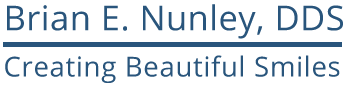 The image shows a logo for a dental practice with the name  Brian E. Nunley, DDS  in white text on a blue background at the top, followed by the words  Creating Beautiful Smiles  below in smaller font. Below the text is an illustration of a smiling face.