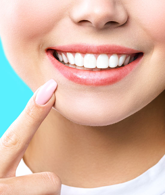 The image features a close-up of a person with a bright smile, showcasing their teeth and facial expression.