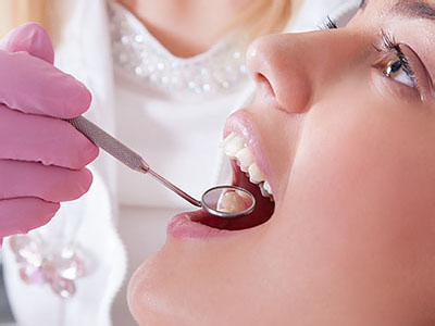 A dental professional assisting a patient during a dental procedure.